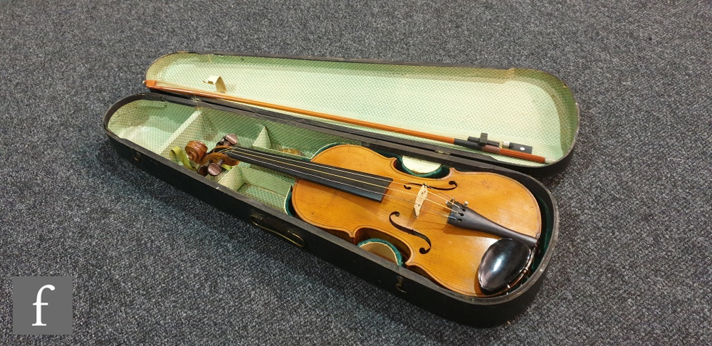 A late 19th to early 20th Century German violin, length of back 36cm, with later bow in black case.