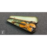 A late 19th to early 20th Century German violin, length of back 36cm, with later bow in black case.