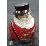 A 1950s hard rubber ice bucket in the form of a beefeater, height 28cm.