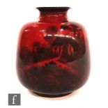 A Royal Doulton Flambe vase of ovoid form with everted rim, decorated with a landscape scene of a