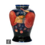 A Moorcroft vase of inverted baluster form decorated in the Pomegranate pattern with a band of whole