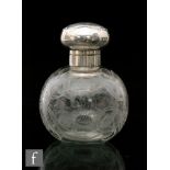 An early 20th Century hallmarked silver and clear glass scent bottle, the globular bottle intaglio