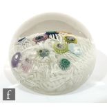 A 20th Century scramble glass paperweight, possible Italian with random millefiori canes over a