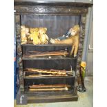 A Victorian carved dark oak open bookcase with adjustable shelves flanked by lion masks and fruit