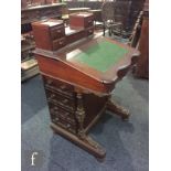 A late 19th Century colonial hardwood davenport, the super structure fitted with four short