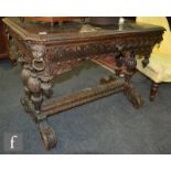 A Victorian carved oak centre table fitted with a single drawer and lion corner mask ring drop