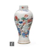 A 19th Century Chinese meiping vase, the white ground enamelled with flowering foliage, rockwork and