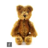 A 1950s Schuco Janus 'two face' miniature teddy bear, cinnamon mohair, one face with black bead