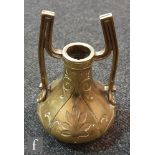 An Arts & Crafts engraved gilt bronze two handled vessel, height 18cm.
