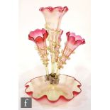 A late 19th Century epergne, the petal edged bowl rising to a central flute flanked by three lower