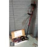 A Minelab X-Terra 305 metal detector with headphones, control box cover, manuals and shovel, boxed.