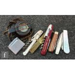 A Second World War military compass MKIII No 294123 by TG & Co London and assorted pocket knives