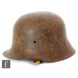 A World War One German helmet with side lugs and later lining.