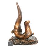 Laurence Broderick - A bronze study of an otter resting on a rock, marked LB, numbered 10/150,