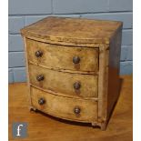 A small Victorian figured walnut three drawer bow front apprentice chest, turned wood handles on