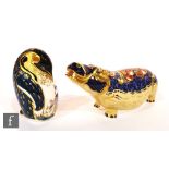 A boxed Royal Crown Derby Penguin and Chick paperweight together with a Hippopotamus paperweight,