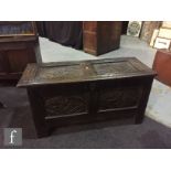 A small 18th century carved oak coffer, the double panelled top over a conforming front on stiles,