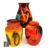 A Poole Pottery ginger jar in the Himalayan Poppy pattern, height 17.5cm, together with two other