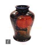 A small Moorcroft vase of inverted baluster form decorated in the Pomegranate pattern, impressed