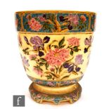 A large late 19th Century Zsolnay Pecs jardiniere of footed cylindrical form enameled with peonies