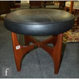 A 1970s teak 'pin wheel' table stool of circular form, raised to strut supports, upholstered in