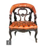 A Victorian carved oak tub shaped easy chair with pierced scroll back, on cabriole legs to the front
