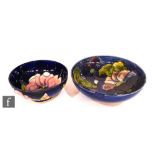 Two Moorcroft footed bowls, the first decorated in the Clematis pattern, the second in the