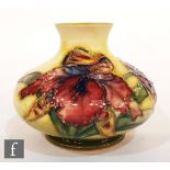 A small Moorcroft vase of compressed form decorated in the Frilled Orchid pattern with tubelined