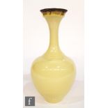 A contemporary studio pottery vase by Bridget Drakeford, the body glazed in a pale yellow with a