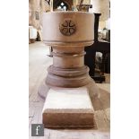 A 20th Century stone circular font with recessed painted gothic roundels on a stepped pedestal