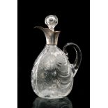 An early 20th Century Stevens and Williams claret jug of dimpled ovoid form with collar neck and