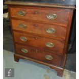 A small George III style chest of four long graduated drawers, oval brass drop embossed handles on