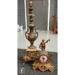 A late 19th Century French gilt metal mantle clock with enamelled dial, surmounted with a gent