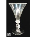 A 19th Century wine glass in the 18th Century taste with trumpet bowl, above two bladed knops and