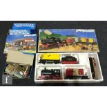 A Playmobil G gauge 4031 Pennsylvania Railroad train set, with a 4301 Riverdale Train Station set,