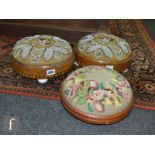 A pair of Victorian Tunbridge ware inlaid circular foot stools on ceramic feet, with Berlin beadwork