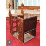 An oak altar chamber/reading stall with carved fleur de lys capitals over detailed armorial side