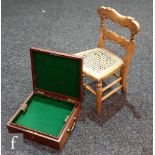 A miniature carved beech child's chair on turned legs and a two handled box fitted with a green