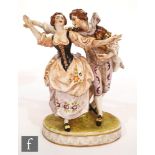 An early 20th Century continental porcelain figure of a courting couple in period dress with