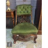 A Victorian mahogany scroll back nursing chair, with serpentine edge seat on cabriole legs,