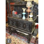 A 17th Century style carved dark oak livery cupboard