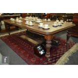 A 19th Century mahogany wind-out extending dining table, the top with thumb moulded edge and with