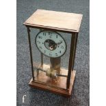 An early 20th Century French Bulle glazed and oak cased electric mantle clock, pillared sides on