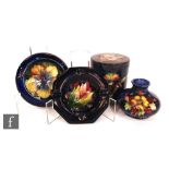 Four pieces of assorted Moorcroft comprising an Orchid pattern circular lidded box and cover, a Leaf