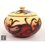 A Moorcroft Pottery lidded pot decorated in the Pasque Flower pattern designed by Philip Gibson,