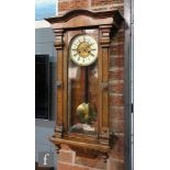 A late 19th Century regulator wall clock with spring driven movement enclosed by a glazed door