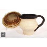 A later 20th Century studio pottery jug of shouldered ovoid form with wide neck and loop handle,