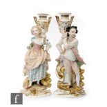 A pair of 19th Century French porcelain figures modelled as a couple in period style dress, each