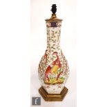 A large 19th Century porcelain lamp base hand enamelled with fanciful birds between gilded