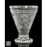 An early 20th Century glass vase of footed conical form with hallmarked silver rim, the main body